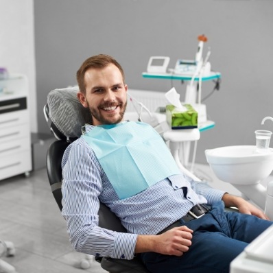 Man smiling in dental chair during visit to Fountain Valley dental office
