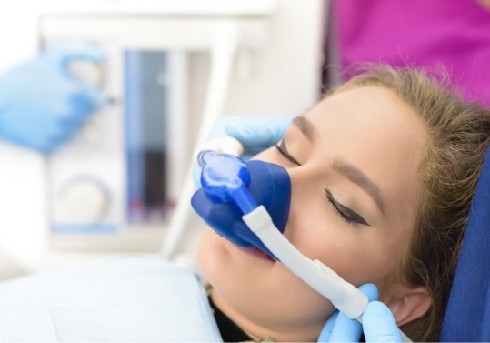 Young woman wearing nasal mask for nitrous oxide sedation dentistry in Fountain Valley
