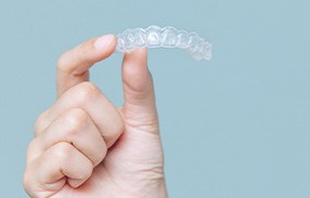 Closeup of patient holding clear aligner