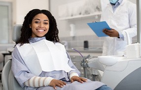 Woman smiling while sitting in treatment chair
