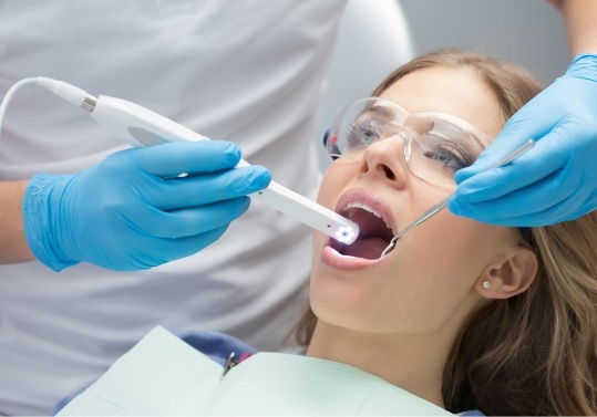 Dentist examining a patient's mouth with an intraoral camera