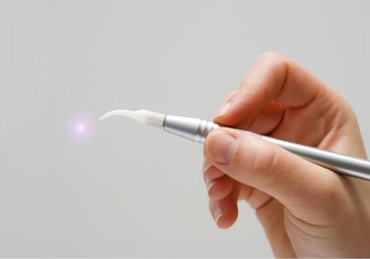 Hand holding a soft tissue laser