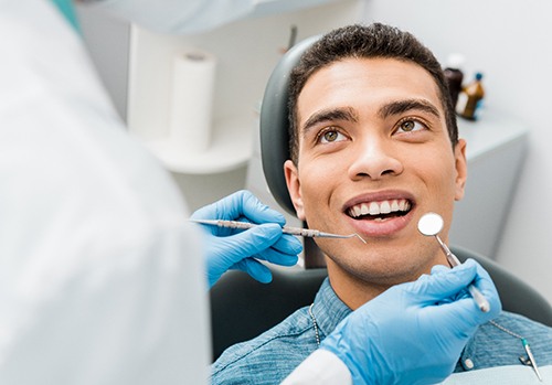 patient smiling while visiting dentist 