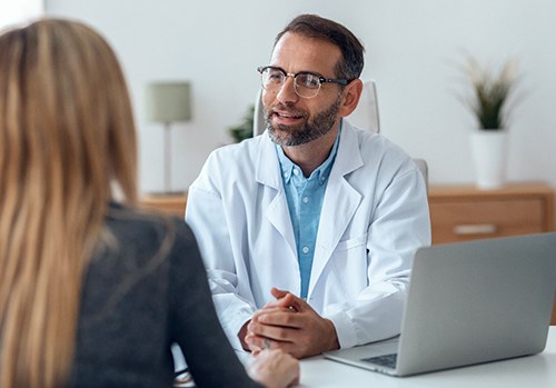 dental professional speaking to patient 