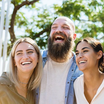 Group of smiling friends who visited a Delta Dental dentist in Fountain Valley