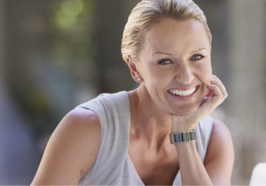 Smiling older woman in gray tank top