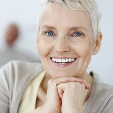 Senior woman grinning with dental implants in Fountain Valley