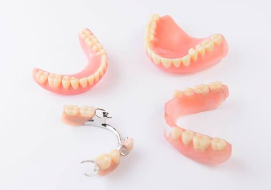 Full and partial dentures against neutral background