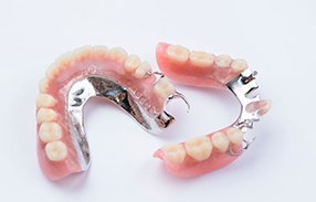 Full upper and lower dentures against white background