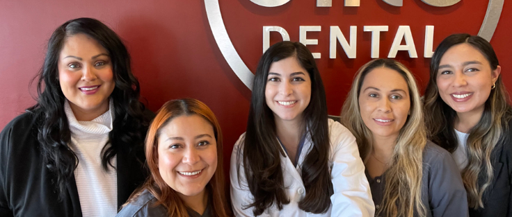 Close up of smiling dental team in reception area