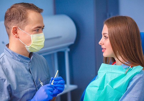 Dentist discussing how a smile makeover works with patient
