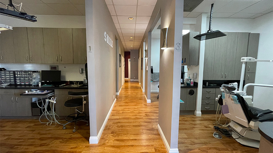 Hallway branching off into several dental treatment rooms