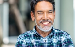 Smiling older man in blue plaid shirt