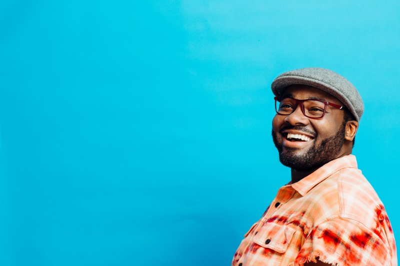 A man smiling with his new cosmetic dentistry treatments