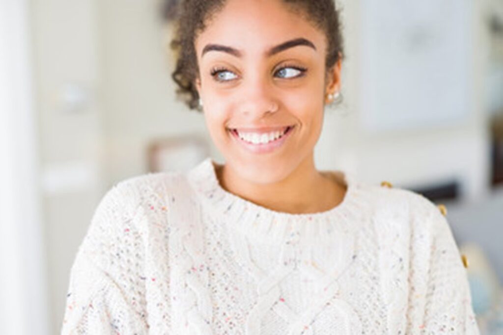 person with nice teeth thanks to dental implants smiling