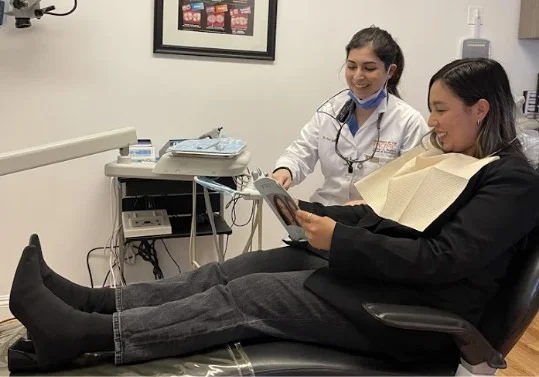 Sara Saber consulting with a dental patient.